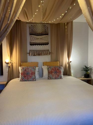 a bedroom with a large bed with a canopy at Layla's in Zermatt