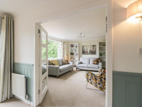 a living room with a door leading into a living room at The Rowans in Newton Stewart