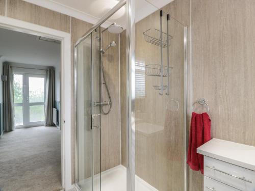 a bathroom with a shower with a glass door at The Rowans in Newton Stewart