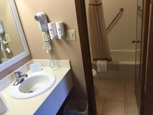 a bathroom with a sink and a phone on the wall at Americas Best Value Inn York in York