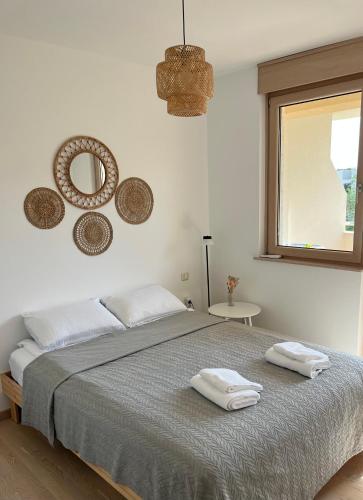 a bedroom with a bed with two towels on it at Montehome sea view in Bečići