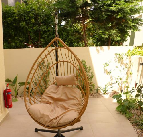 a hanging chair with a pillow on a patio at FaliroRelax F2 in Athens