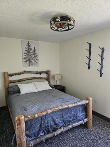 a bedroom with a wooden bed in a room at Salt River Lodge in Thayne
