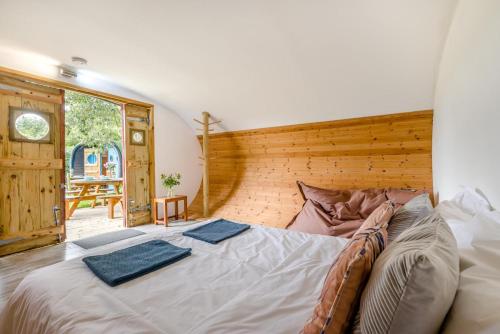 a bedroom with a large bed with two towels on it at 1 Bed in Bude oc-s34852 in Bude
