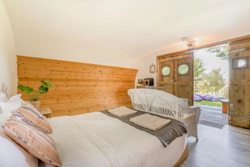 a bedroom with a large white bed and a window at 1 Bed in Bude oc-s34849 in Bude