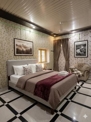 a bedroom with a large bed and a chair at Vaishno Atithi Bhawan in Naimishāranya