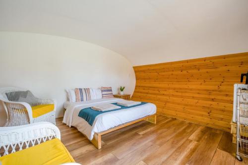 a bedroom with a bed and two wicker chairs at 1 Bed in Bude oc-s34850 in Bude