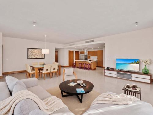 a living room with a couch and a table at 3BR Beachfront Private Pool Ultravioleta Cabarete in Cabarete