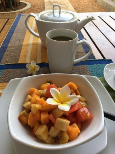 a bowl of food on a table with a cup of coffee at Sky and Sand Guesthouse in Beruwala