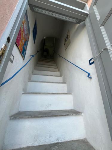 a stairway with white stairs with blue tape at Casa MiraMare in Procida