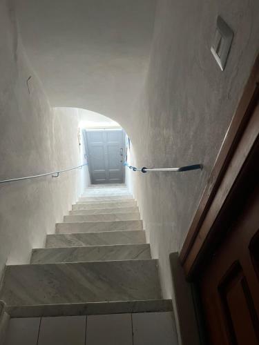 a stairway with a blue door in a building at Casa MiraMare in Procida