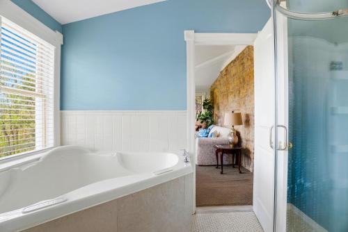 a bathroom with a tub and a shower at St. Croix Valley Inn in Shafer