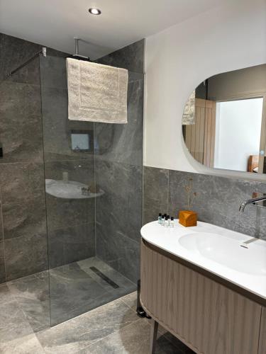 a bathroom with a sink and a shower at Barnfield house in Upham