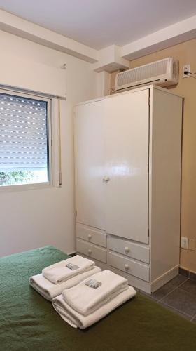 a bedroom with two towels sitting on a bed at Hotel Cafayate Design in Cafayate