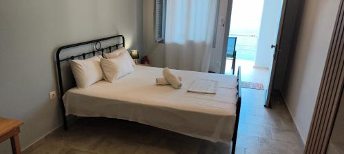 a bedroom with a large bed with white sheets and pillows at Thea Monastiraki in Nafpaktos