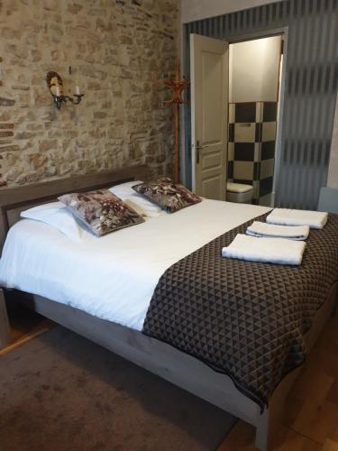 a bedroom with a large bed with towels on it at l'authentique in Saint-Amand-Montrond