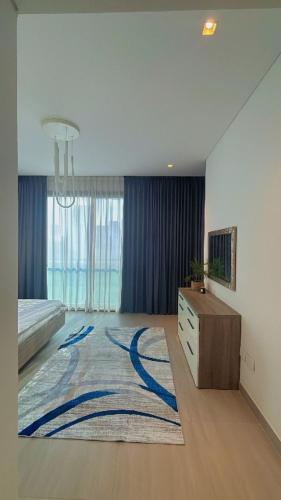 a bedroom with a bed and a rug on the floor at Home Sweet Home in Abu Dhabi
