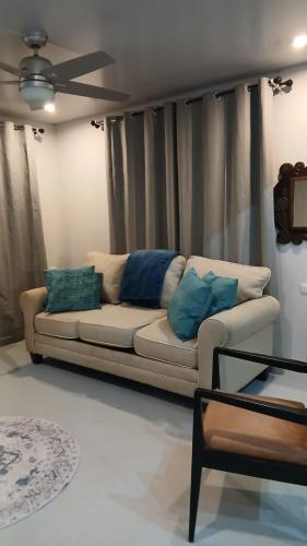 a living room with a white couch with blue pillows at Casa Magnolia in El Socorro