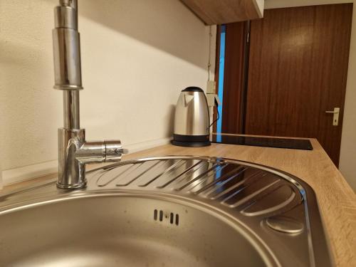 a kitchen sink with a faucet on a counter at Ferienzimmer-Monteurzimmer in Sibbesse