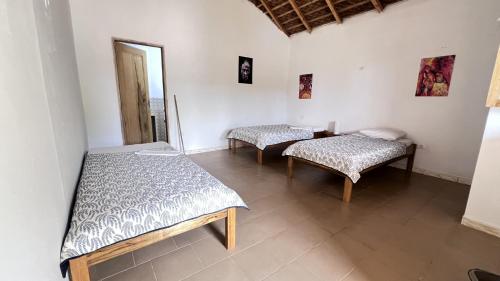 a room with two beds and a table at Vacaciones Timonier in Mar Lodj