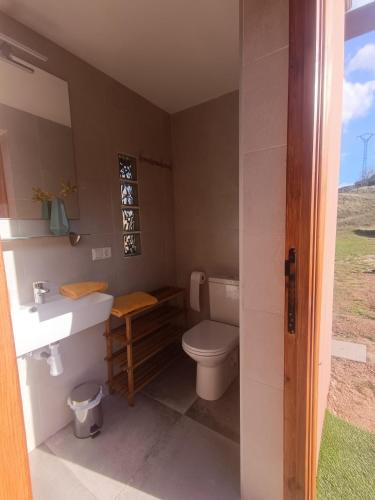 a bathroom with a toilet and a sink at El Astial De Ezquerra - Camp in Ezquerra