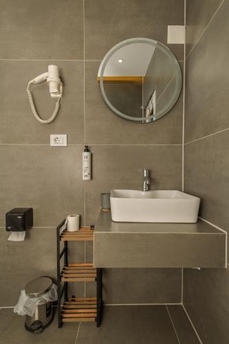 a bathroom with a sink and a mirror at DejaVu Hotel in Prizren