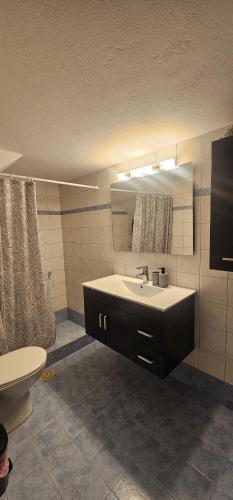 a bathroom with a sink and a toilet at MaryAnn's house in Livadi