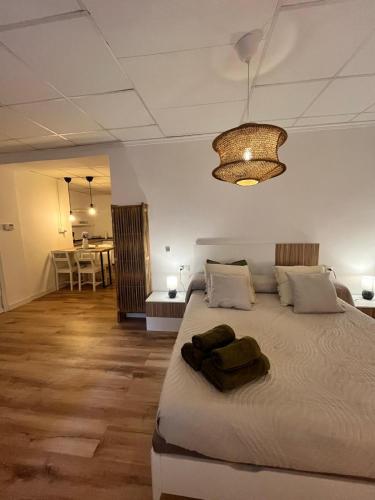 a bedroom with a large bed and a chandelier at Casa Portalet in Xàtiva