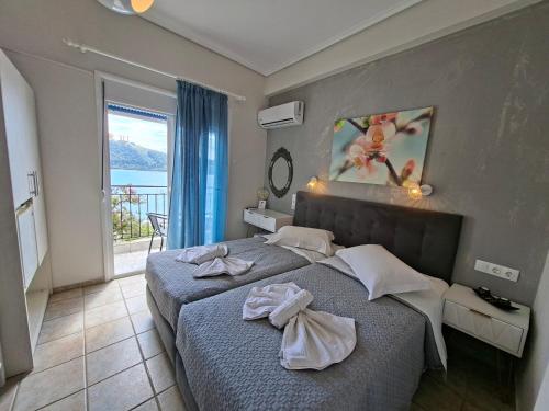 una camera da letto con un letto e una grande finestra di Babis a Città di Skiathos