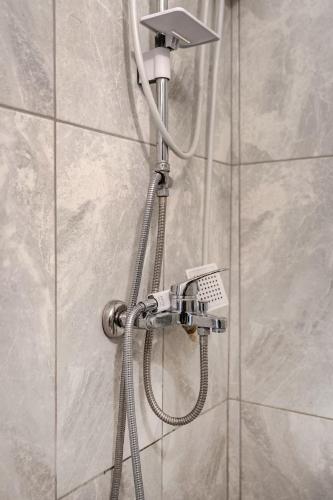 a shower with a shower head in a bathroom at Güneş Villa in Antalya