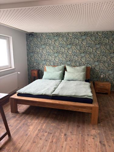 a large bed in a room with a wall at FeWo Johann Friedrich in Hilpoltstein