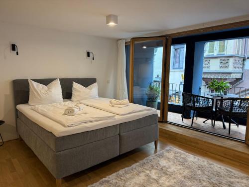 a bedroom with a bed and a balcony at AltstadtOase in Konstanz