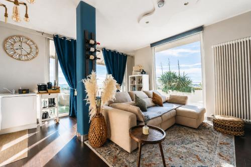 a living room with a couch and a large window at Suite Apartments Rimini - Seafront in Rimini