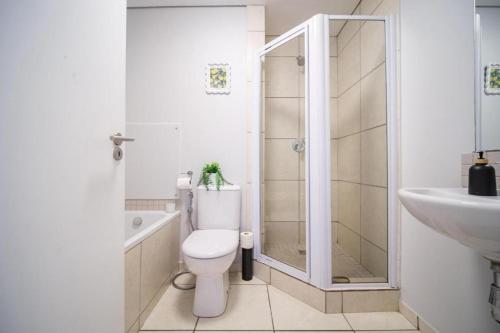 a bathroom with a toilet and a sink and a shower at Ballito Exotic Lifestyle in Ballito