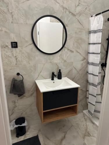 a bathroom with a sink and a mirror at House Burić in Otočac