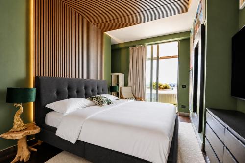 a bedroom with a large bed and a large window at Suite Apartments Rimini - Seafront in Rimini