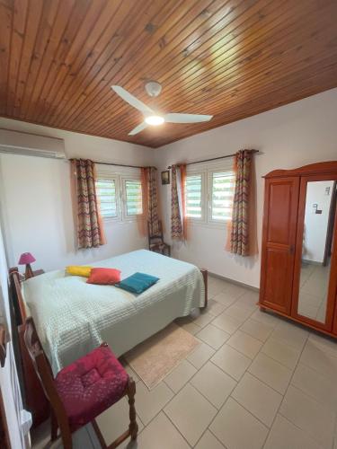 a bedroom with a bed and a wooden ceiling at CD House in Fort-de-France