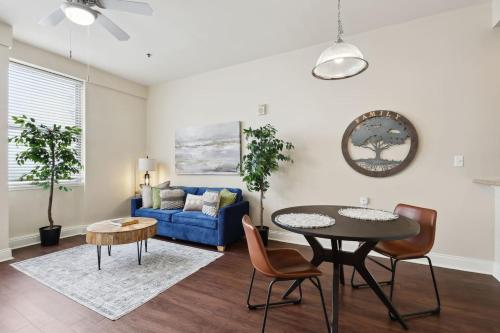 a living room with a table and a blue couch at Suite Bleu 5 Min walk to Bourbon st Rooftop Pool in New Orleans