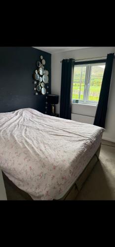 a bed in a bedroom with a window at edinburgh holiday home in Roslin