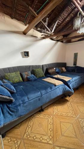 a large blue couch in a living room at La Gruta Glamping in Fúquene