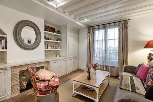 a living room with a couch and a table at Le Passage Du Marais in Paris