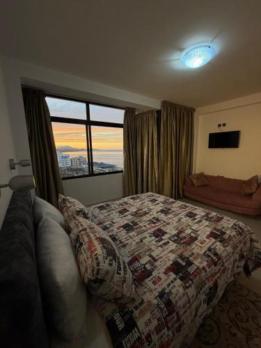 a bedroom with a bed and a large window at Étoile in M'diq
