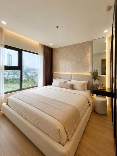a large bed in a bedroom with a large window at Ocean Nest - 2BR Apartment in Ocean Park in Gia Lâm Pho