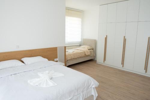 a bedroom with a white bed with a bow on it at Hotel Han Gusinje in Gusinje