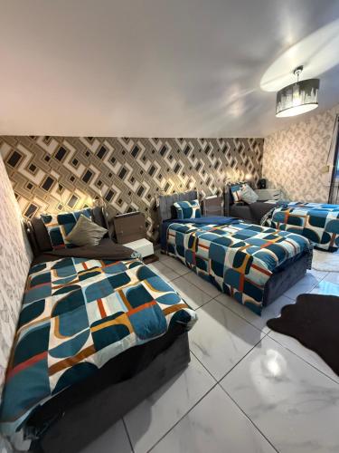 a bedroom with two beds and a couch at Sirine57 Charming House for 5 Guests Large Private Parking for Cars Vans in Florange