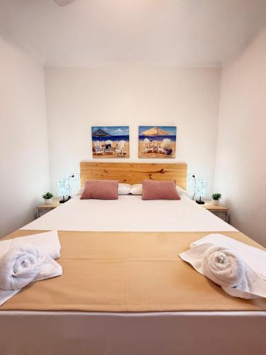 a bedroom with a large white bed with two pillows at Brisas del mar in Faro de Cullera