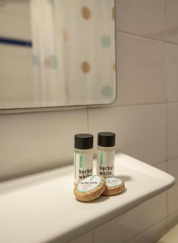 a bathroom counter with two bottles of toiletries on it at Violetta Hotel in Amoudara Herakliou