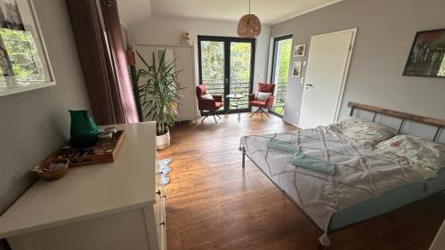a bedroom with a bed and a living room at Dom przy Panke in Kolonie Röntgental