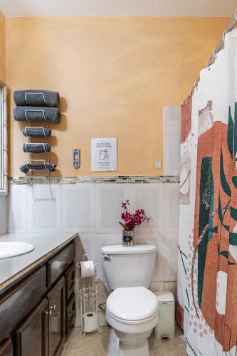 a bathroom with a white toilet and a sink at Mona Master suite in Kingston