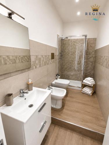 a bathroom with a sink and a toilet and a shower at Regina Suite Mazara in Mazara del Vallo